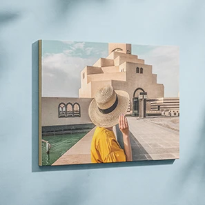 Foto einer Frau mit Strohhut vor Architektur, auf Holz aufgezogen