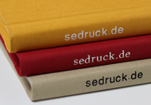 Hardcover linen bookbinding in beige, red & yellow