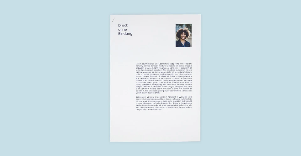 A4 printouts with corner stapling on blue background
