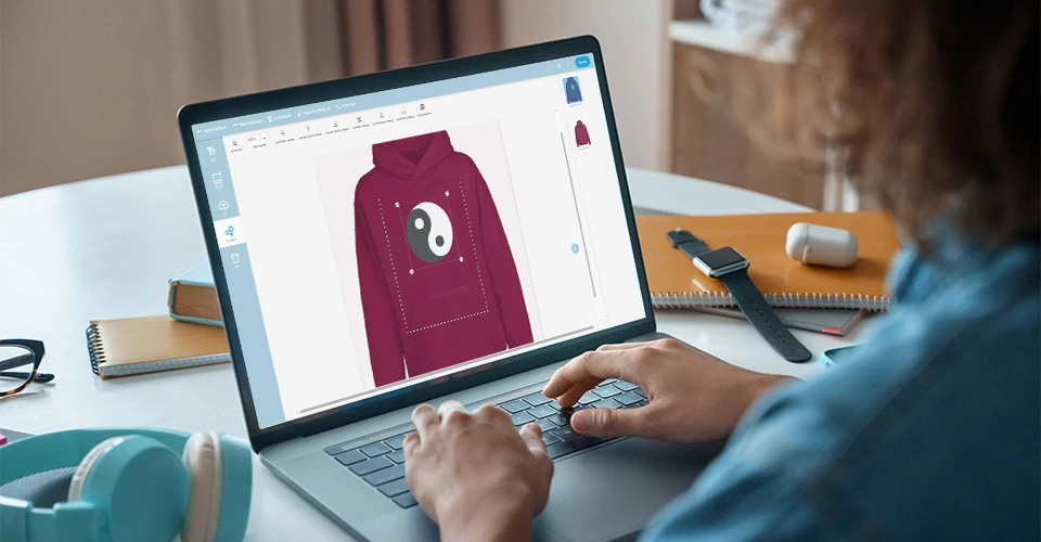 Customer designing a hoodie at her desk using the online designer