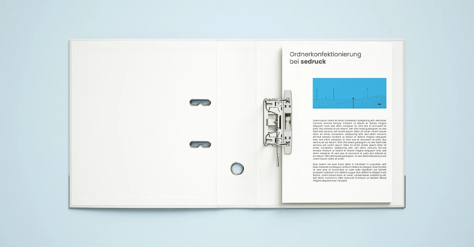 Opened binder with contents viewed from above on blue background