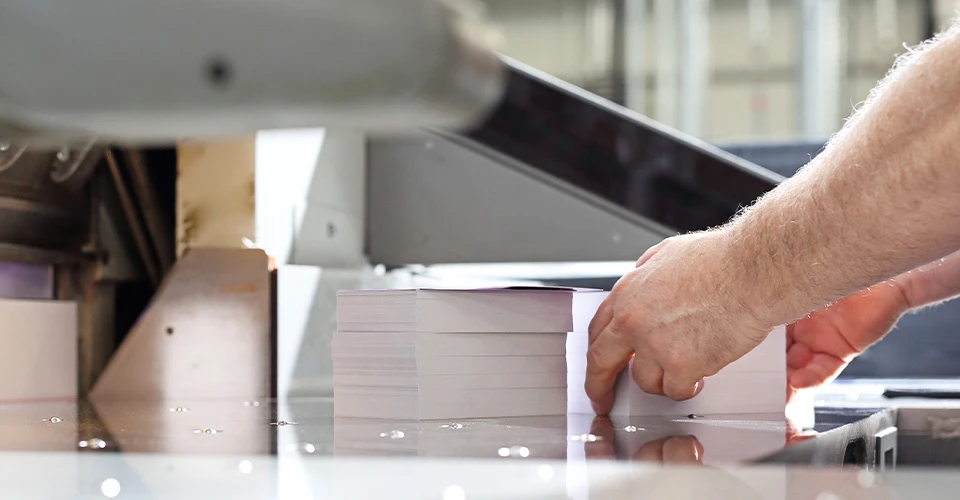 Book block being trimmed at a cutting machine